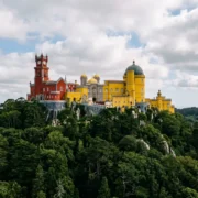 Pena Palace on its hilltop in Sintra, the red and yellow towers above the forest