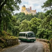 The tourist bus climbing the forested road to Pena Palace in Sintra