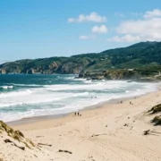 The wild Atlantic beach and dunes of Praia do Guincho with the Serra de Sintra behind