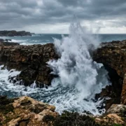 Waves exploding through the Boca do Inferno sea arch on the Cascais coast
